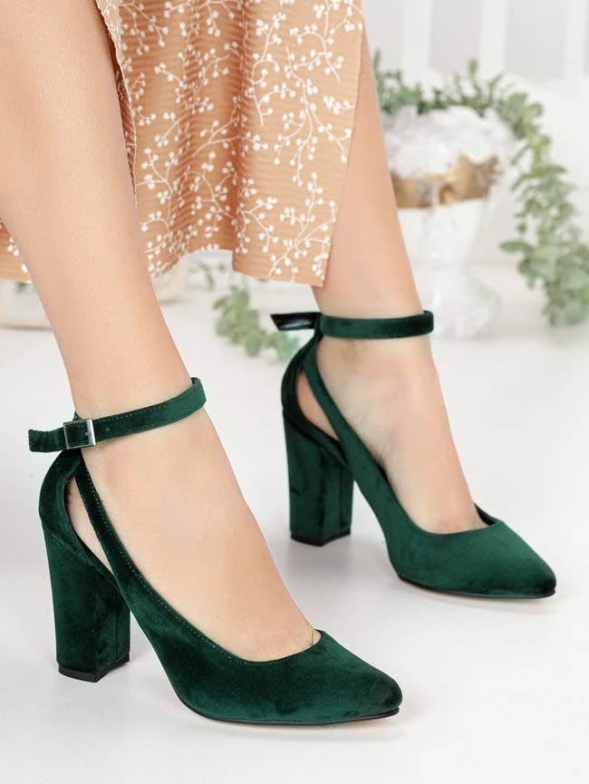 model wearing the green velvet heels