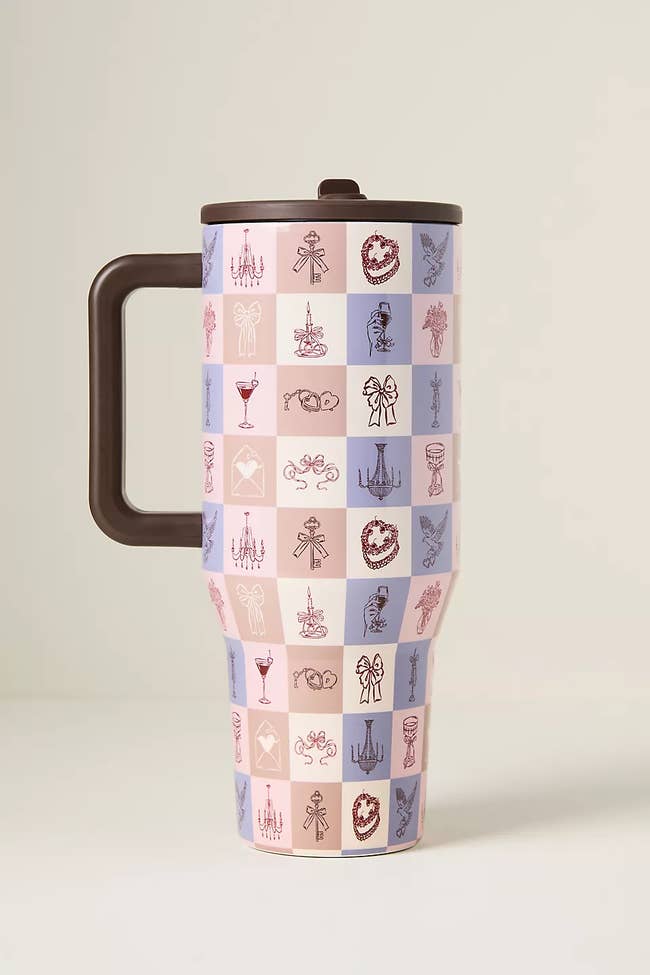 Travel mug with a checkered signifier featuring assorted decorative icons including chandeliers, cakes, and cups