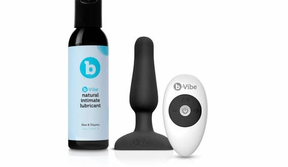 Bottle of Natural Intimate Lubricant, black novice anal plug and white wireless remote