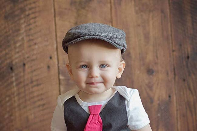 a child wearing the newsboy cap in gray and white design