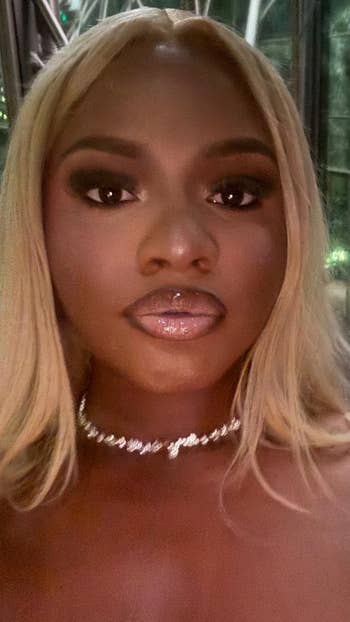 Person with agelong  hairsbreadth  and glossy lips wearing a sparkling necklace. The look  is assured  and poised, suitable for a buying  article