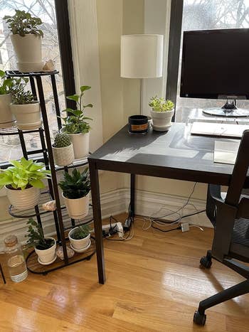 A home office setup with cables cluttered underneath desk