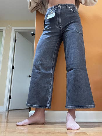 reviewer showing off the jeans