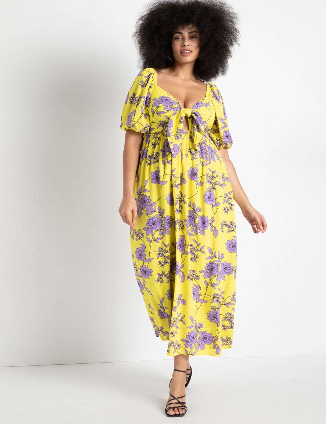 model wearing tie front yellow and purple maxi with short puff sleeves
