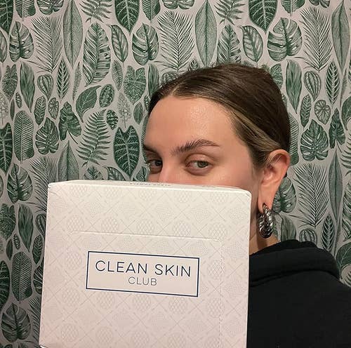 Reviewer holding up a box of disposable face towels