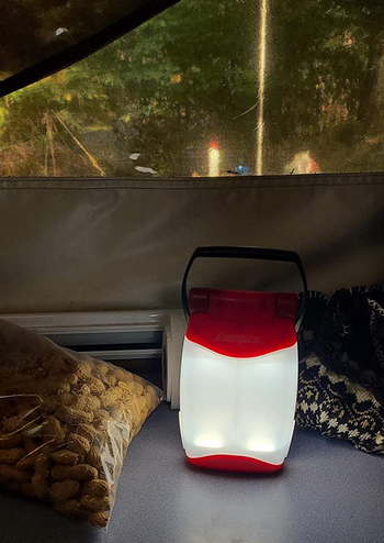 reviewer photo of lantern lighting up the inside of a tent