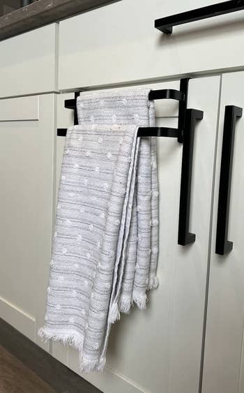 Textured kitchen towel hanging on a black drawer handle in a modern kitchen