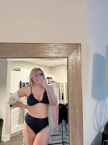 Woman in a lace bikini posing for a selfie in a mirror