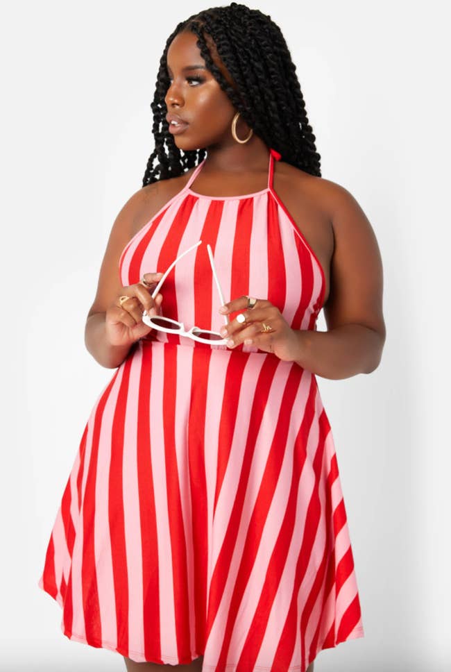 a model wearing the bellini striped halter dress