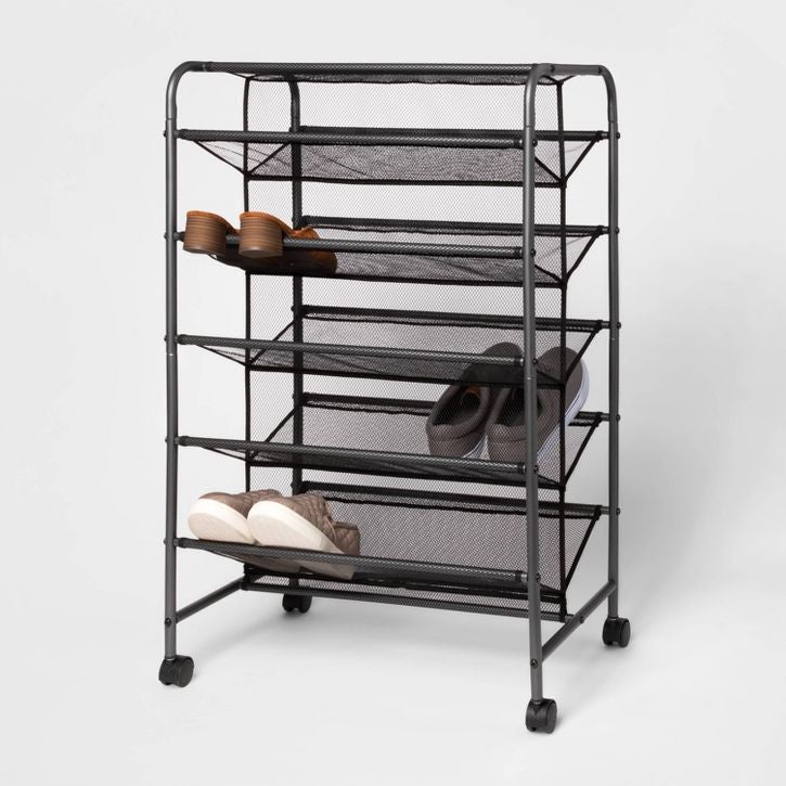 rolling mesh shoe rack with shoes on it