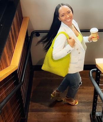 review with the green tote bag on their shoulder