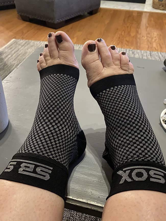 reviewer wearing the compression socks in black