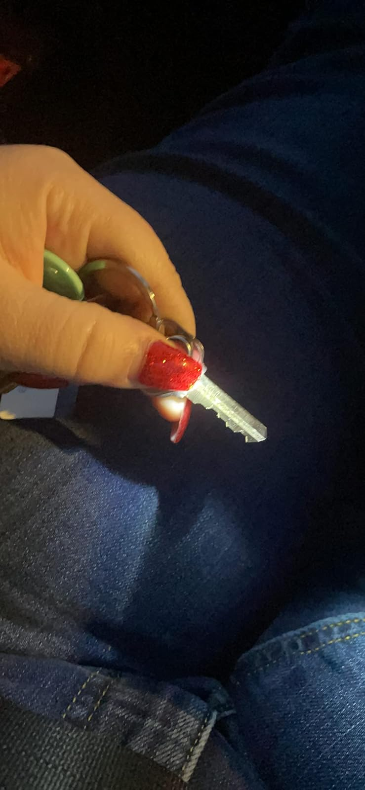 Reviewer holding down the thumb light attached to a key