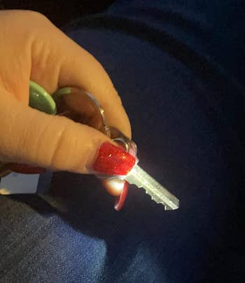 Reviewer holding down the thumb light attached to a key