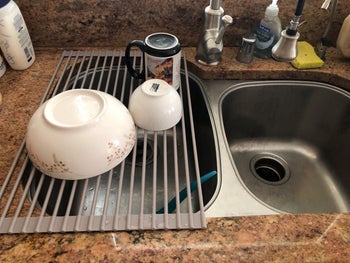 reviewer photo of bowls drying over over-sink dish rack