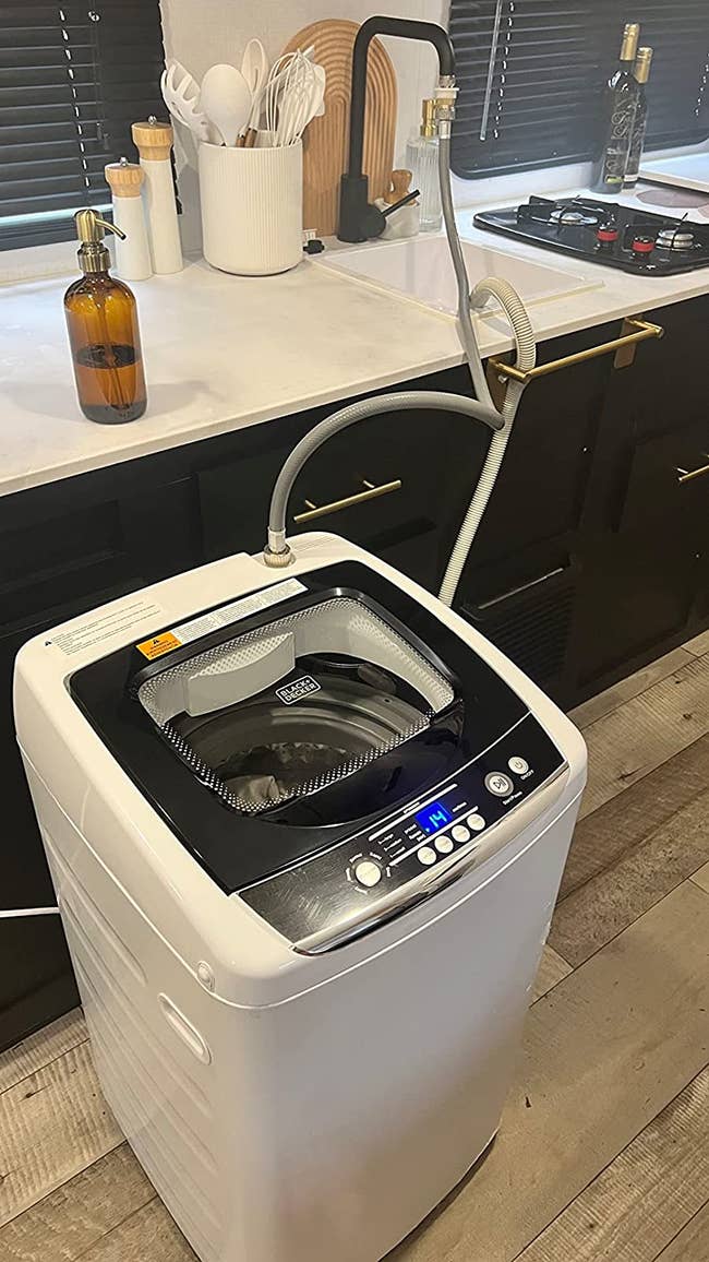 The washing machine hooked up to a sink in a reviewer's kitchen