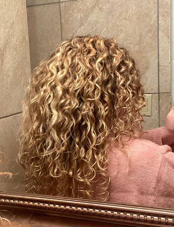 image of reviewer with medium length blonde curls