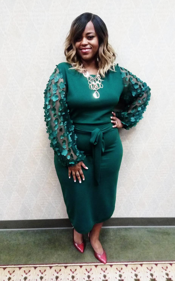 reviewer wearing the dress in green