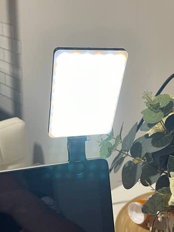 a reviewer's clip light attached to their desktop monitor