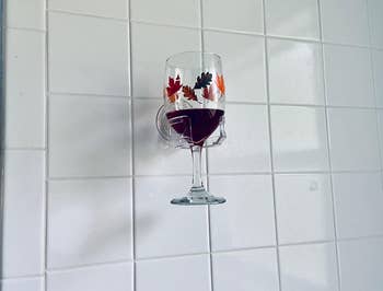 reviewer image of a glass of red wine resting in the wine holder