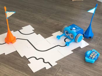 The robot on a cardboard track next to a remote control