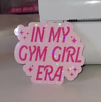 a pink barbie style sticker that says 