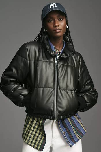 a model wearing the jacket in black 
