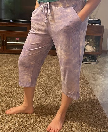 a reviewer wearing the capris in purple tie-dye 