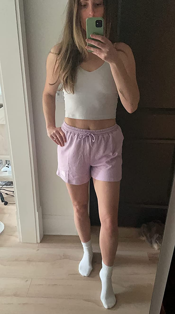 reviewer wearing lilac-colored shorts