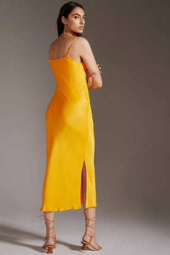 back of model wearing the yellow dress with sandals