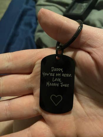 Person holds a keychain with thoughtful engraving