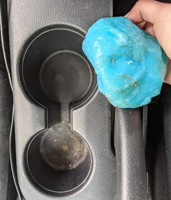 different reviewer showing the blue cleaning gel covered with grime that was inside of a car's cup holder