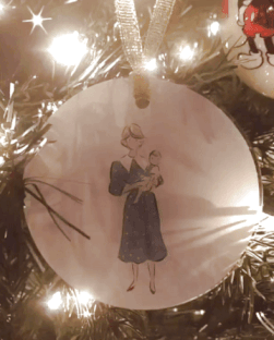 a gif of a princess diana ornament of diana with william as a baby