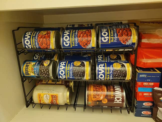 A can organizer stocked with cans neatly