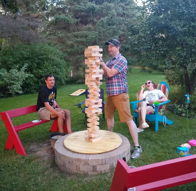 reviewer image of three people playing with the giant stacking game outside