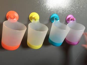 four colorful cups hung in a row