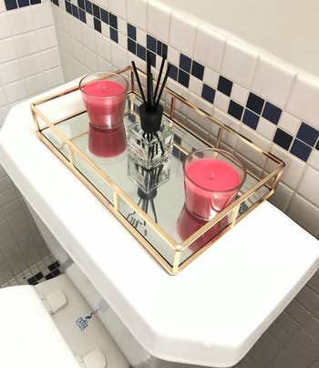 another reviewer's mirrored tray connected a toilet vessel with 2 candles and a diffuser, perfect for a stylish bath decor setup
