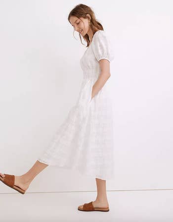 model wearing the white mdi dress, side view