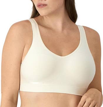 Person wearing a seamless, supportive sports bra in beige