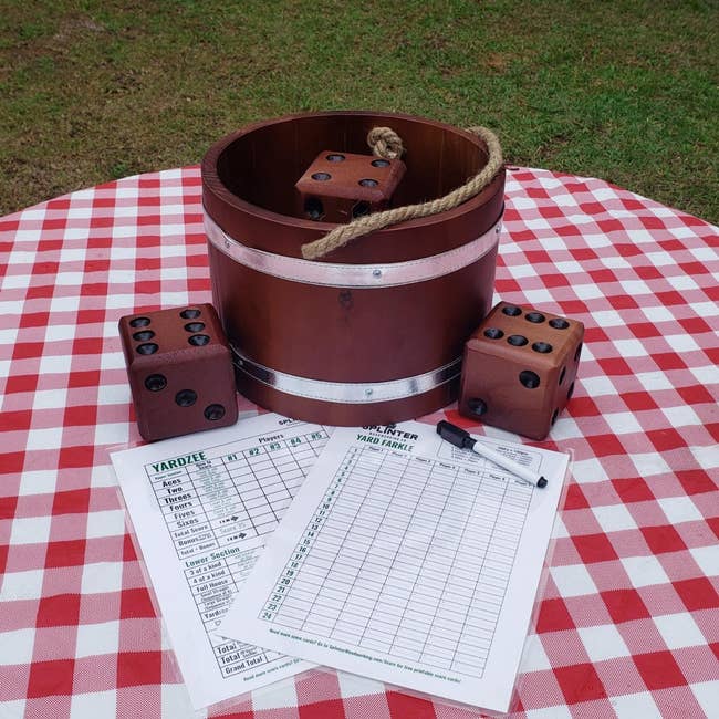 Yardzee crippled acceptable connected a checkered tablecloth, with ample woody dice, a bucket, people sheets, and a dry-erase marker