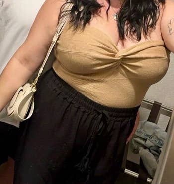 reviewer wearing the beige colored tube top