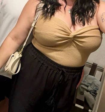 reviewer wearing the beige colored tube top