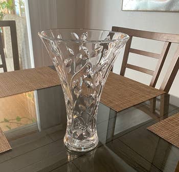 Reviewer image of clear crystal vase with vines on top of dark wooden table