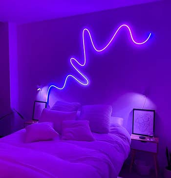 the rope light glowing purple above a bed