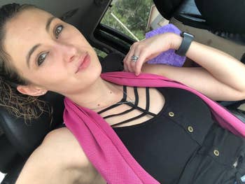 A reviewer wearing the cooling towel astir neck