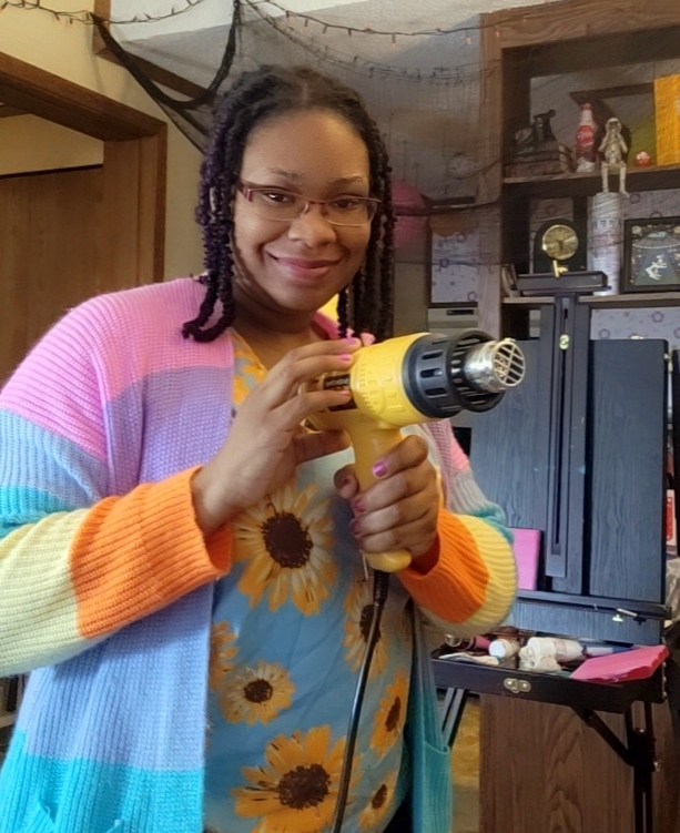 Writer holding heat gun