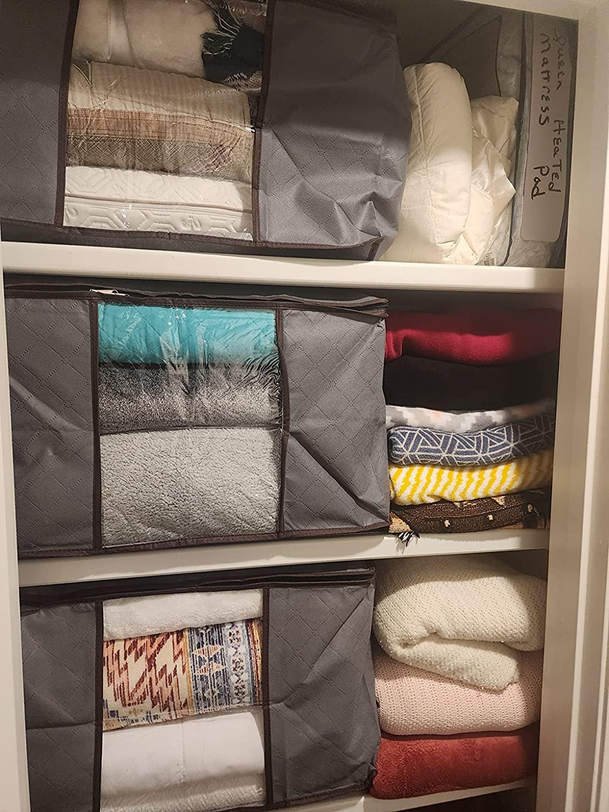 on decision making and problem solving Three gray zippered rectangular storage bags with a panel showing the towels and comforters inside them
