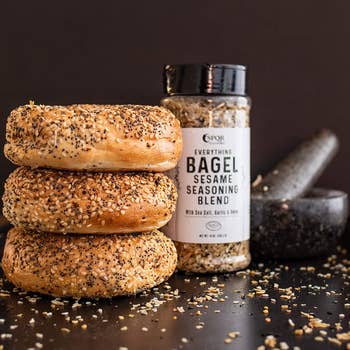 the seasoning in its container and a stack of everything bagels