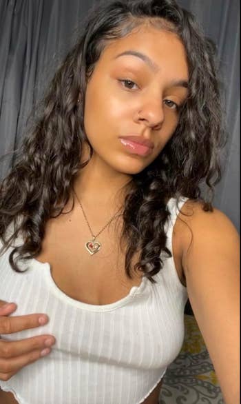 Person successful a sleeveless apical and necklace takes a selfie, showcasing jewelry for a buying article