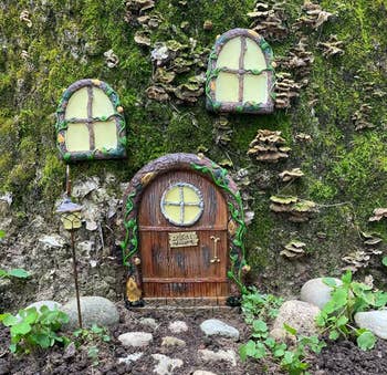 Fairy-tale style miniature door and windows set into a garden wall